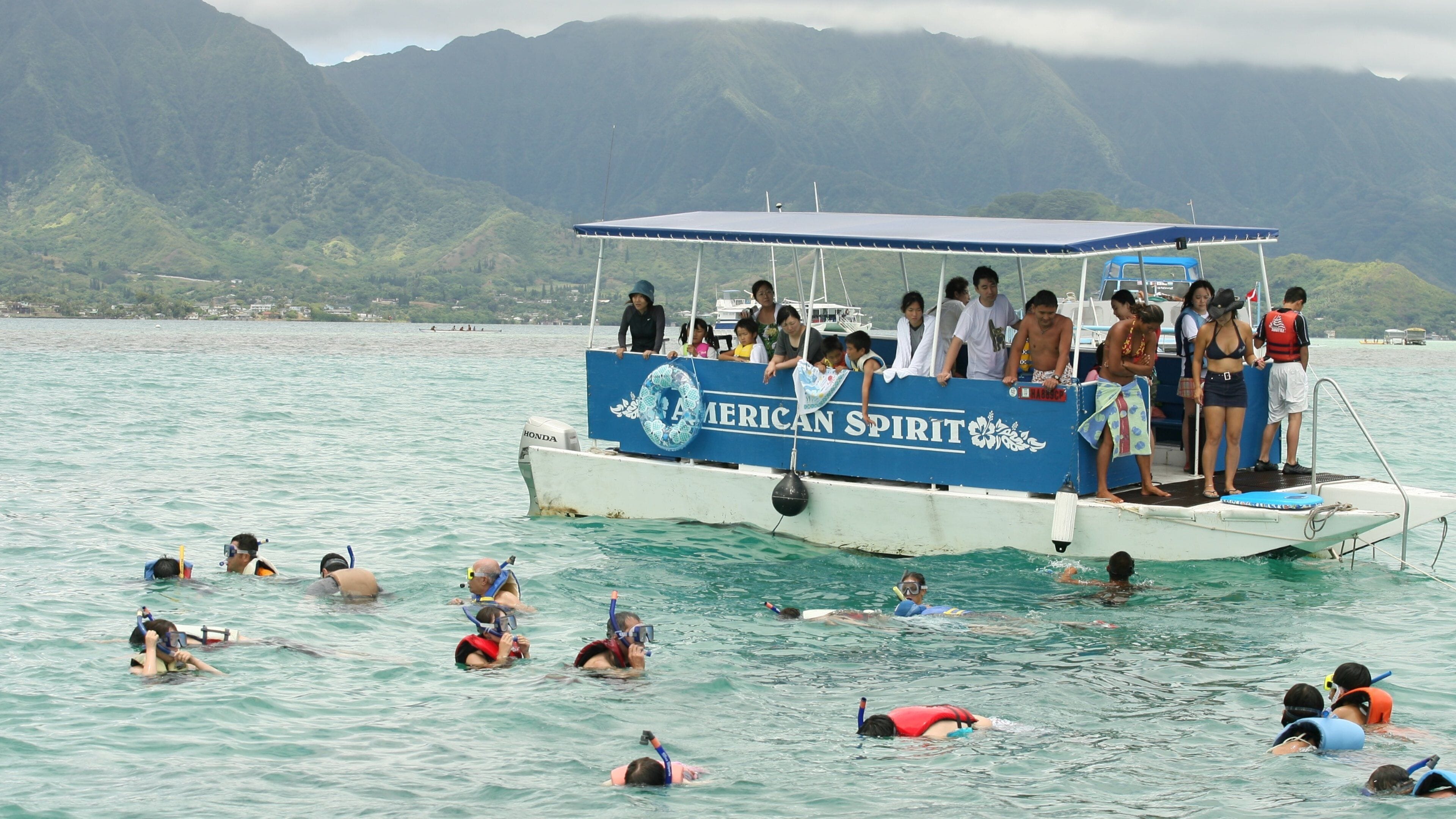 Kaneohe which includes general coastal views and boating as well as a large group of people
