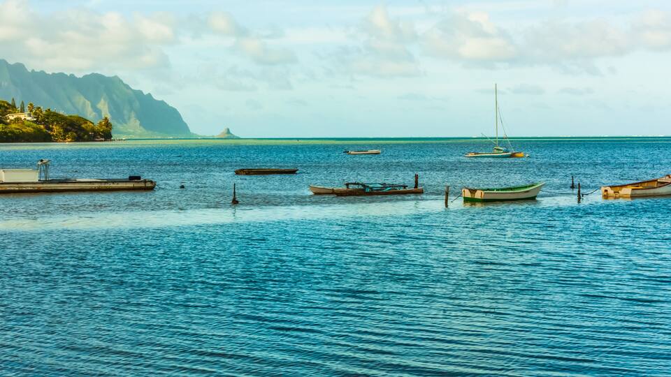 Small Fishing Boats Moored Near Heeia Kea Marina With Mokolii Island (Chinamans Hat) Across Kaneohe Bay, Oahu, Hawaii, USA