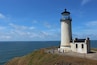 A lighthouse with a clear sky and calm sea.