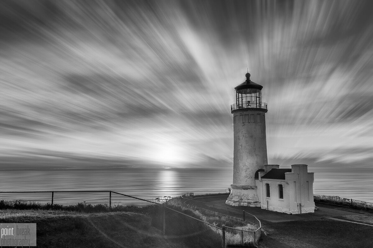 A lighthouse with a long exposure effect, creating light streaks in the sky.