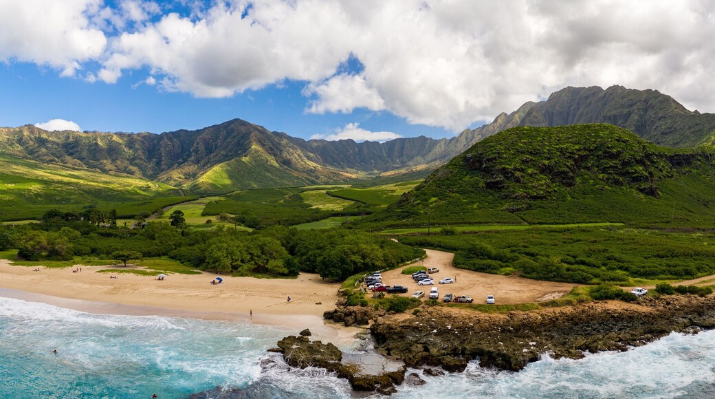 Broad panorama of Makua beach and valley from aerial view over the ocean on west coast of Oahu, Hawaii