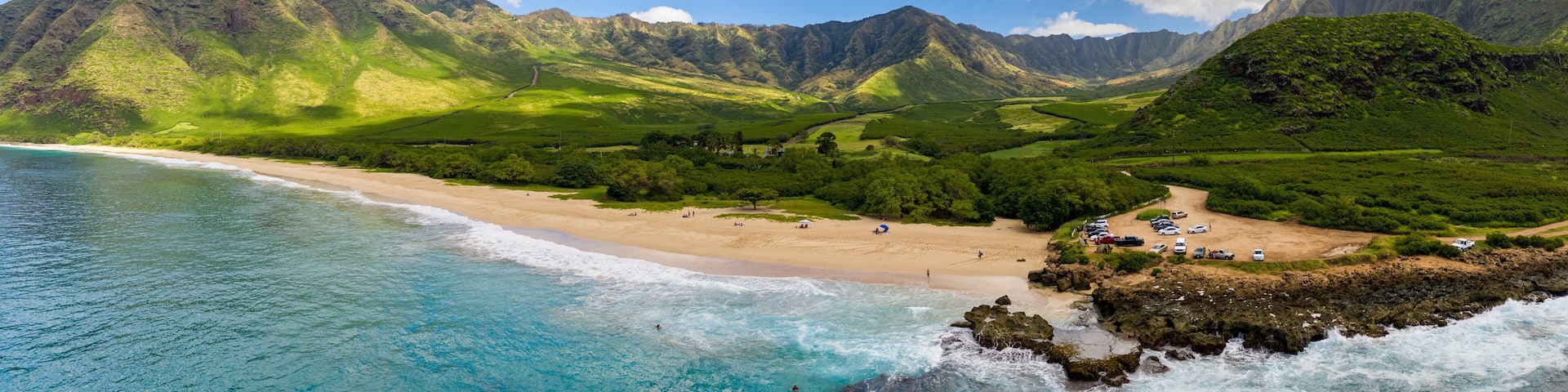 Broad panorama of Makua beach and valley from aerial view over the ocean on west coast of Oahu, Hawaii