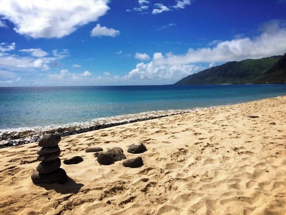 The water color here is so beautiful and I love how someone carefully stacked the rocks.  The sand contrasts so nicely with the water and not a person in sight! #LifeatExpedia
