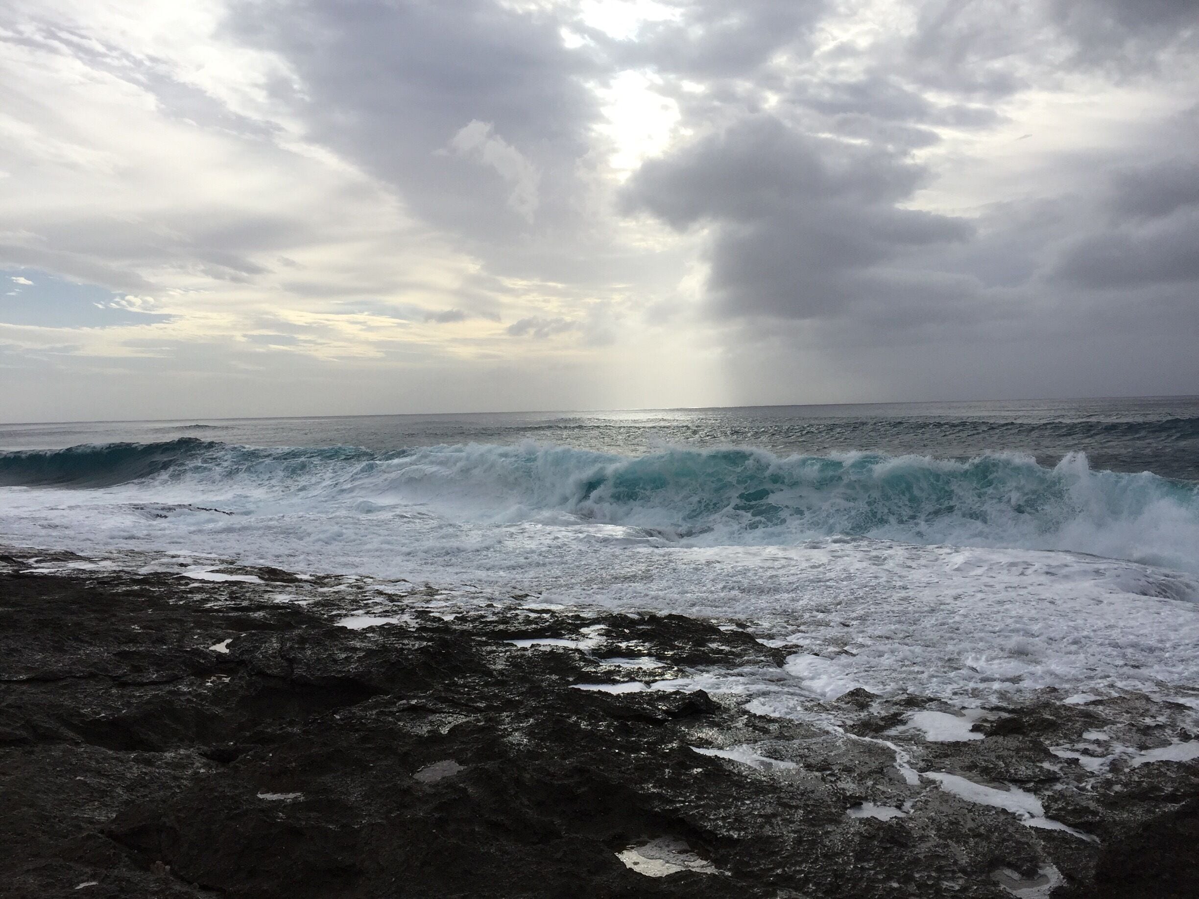 Found this sparsely populated beach on Oahu’s west side. Powerful waves in February pounding in rock and sand beach. #merch