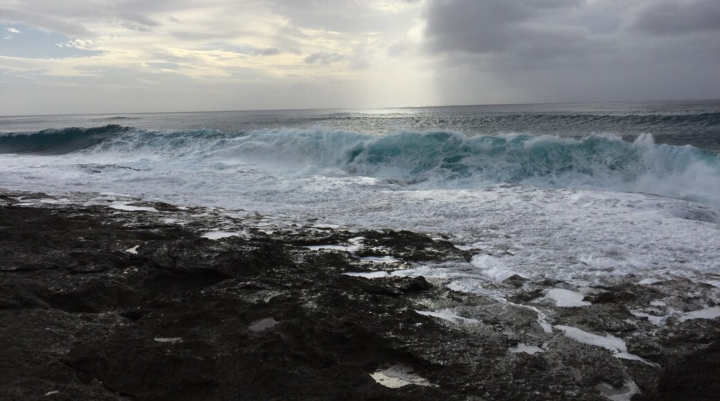 Found this sparsely populated beach on Oahu’s west side. Powerful waves in February pounding in rock and sand beach. #merch