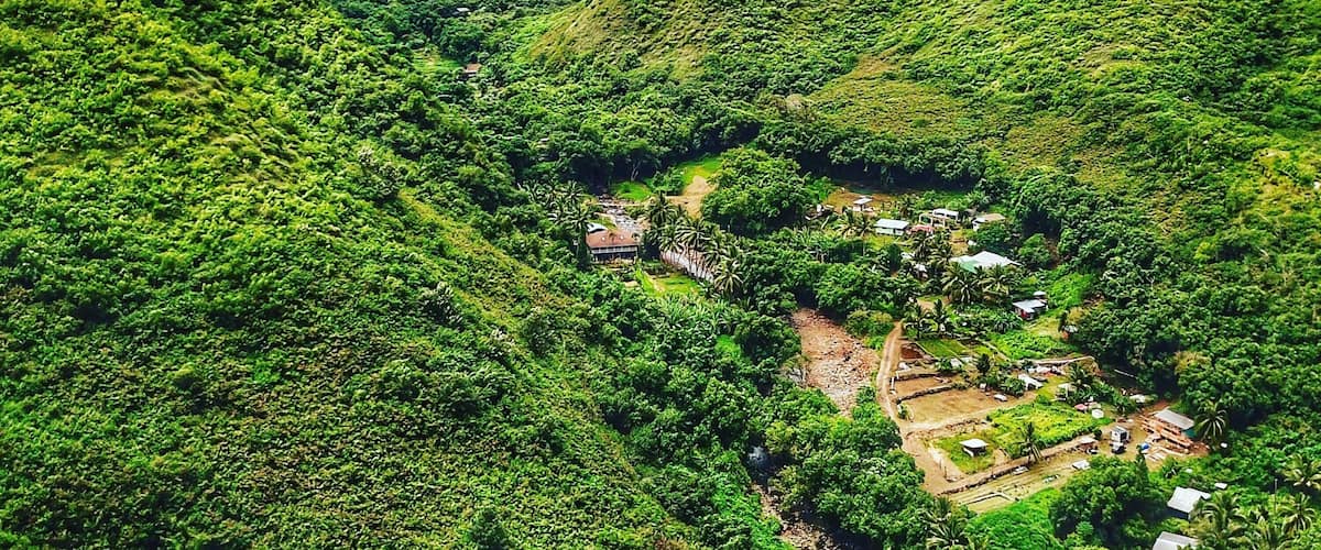 Drone shot from the coast looking up the canyon and over the village. The is one the NE road to the blowhole in Maui