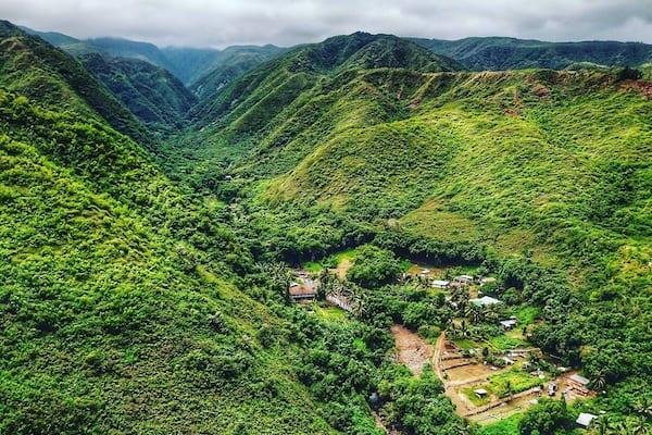 Drone shot from the coast looking up the canyon and over the village. The is one the NE road to the blowhole in Maui