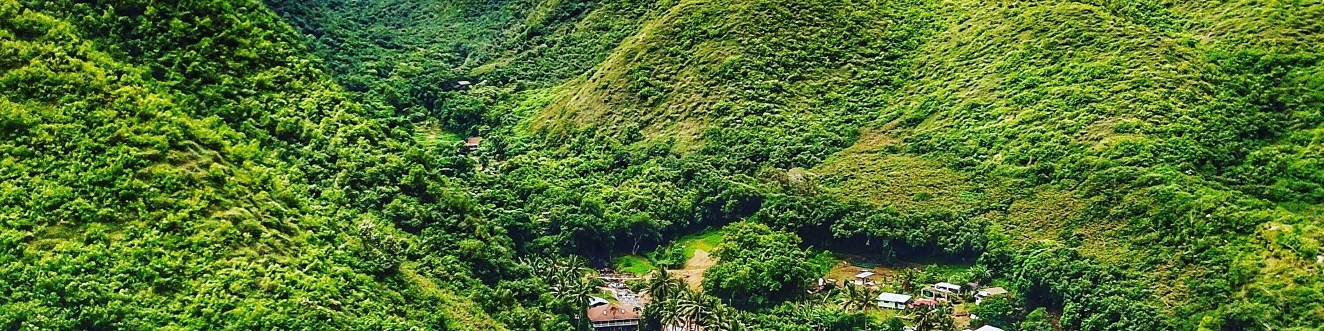 Drone shot from the coast looking up the canyon and over the village. The is one the NE road to the blowhole in Maui