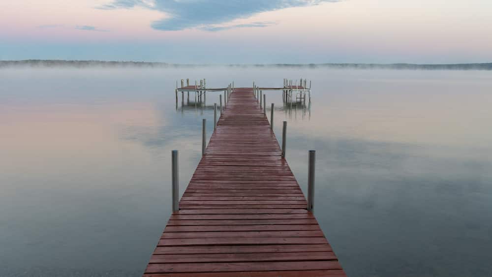 Dock on Mullett Lake in Indian River Michigan with pastel skies overhead