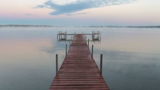 Dock on Mullett Lake in Indian River Michigan with pastel skies overhead