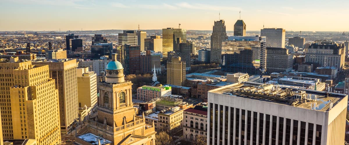 A cityscape with a mix of historic and modern buildings, including a prominent dome and a tall skyscraper.