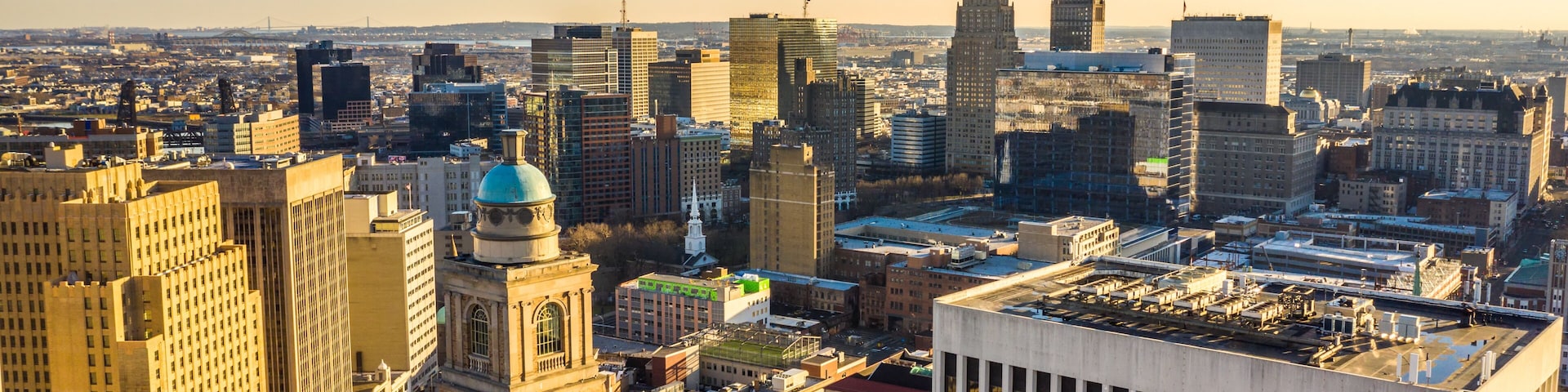 A cityscape with a mix of historic and modern buildings, including a prominent dome and a tall skyscraper.