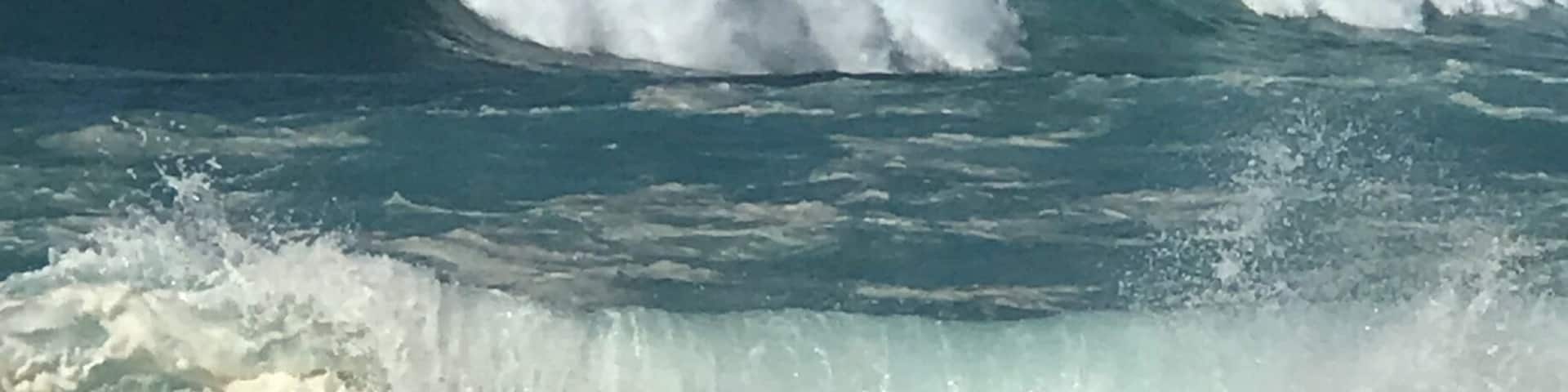 A beach with large waves crashing onto the shore.