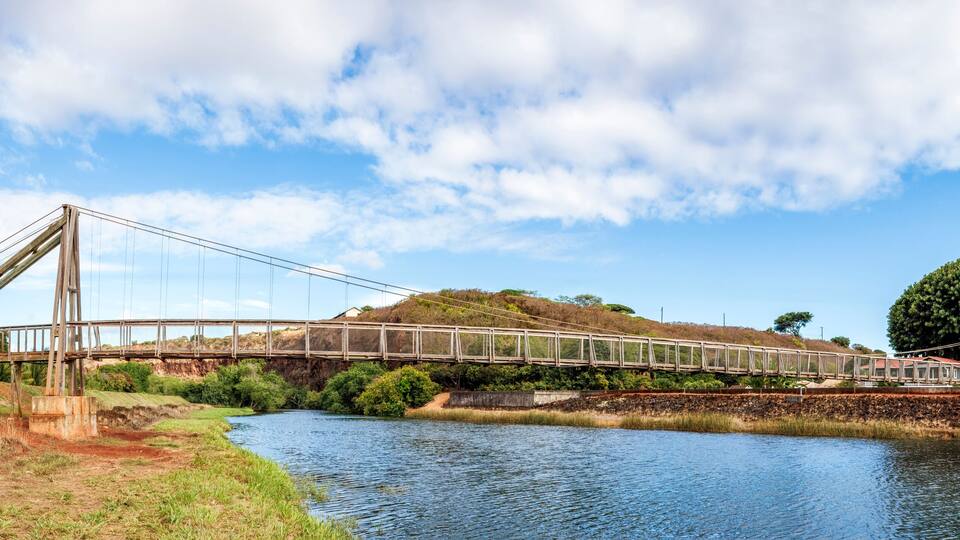 The historic Hanapepe Swinging Bridge, located on Kauai, Hawaii, was built in 1911. The pedestrian suspension bridge connected the town of Hanapepe with agricultural fields in the Hanapepe Valley.
