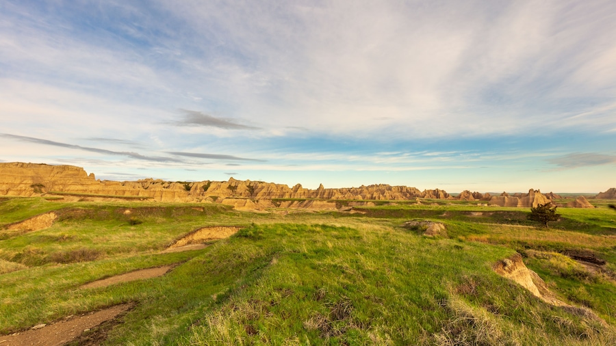 Morning breaks over the hills and grassland of Badlands National Park on Notch Trail