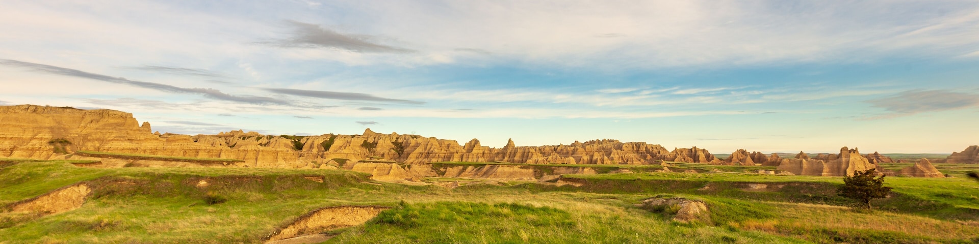 Morning breaks over the hills and grassland of Badlands National Park on Notch Trail