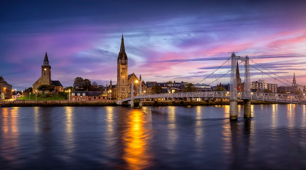 Panoramic view of the cityscape of Inverness, Scotland, during evening time with Greig Street Bridge, River Ness and the old town
