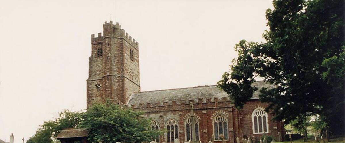 A historic church with a tall tower and arched windows.
