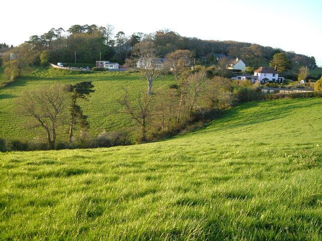 Vicarage Lane, Longdown from Perridge Cross. Near Longdown (of which these houses form a detached "suburb") the B3212 crosses a col between the Exe and Teign watersheds; the fields in the foreground drop west to the Teign.