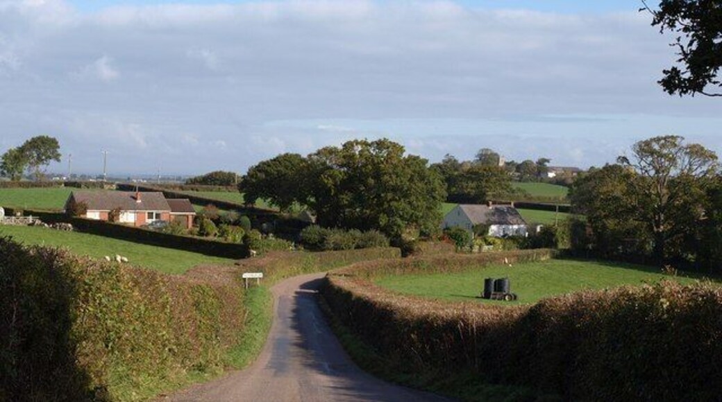 Approaching Hittisleigh. Taken a little further down the lane shown in 1551643. The group of buildings forms a separate southwest part of the scattered village; 991666, visible right of centre, is over 700 metres beyond them.