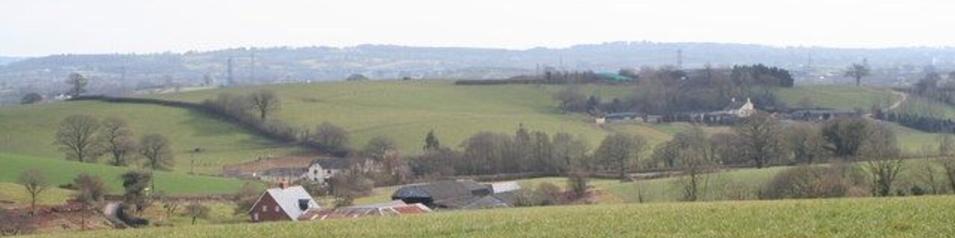 Field above Clapp Mill Farm The buildings on the hillside beyond are those of Townhill Farm at Westwood.