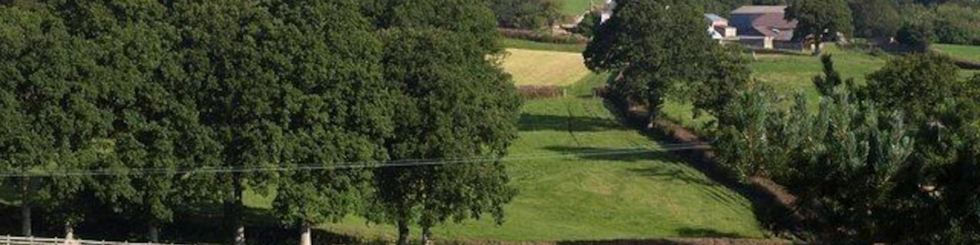 View from the cemetery, Tedburn St Mary. A view from 1492364 across a small valley that drains to the right to the Lilly Brook. On the right is Great Fairwood Farm.
