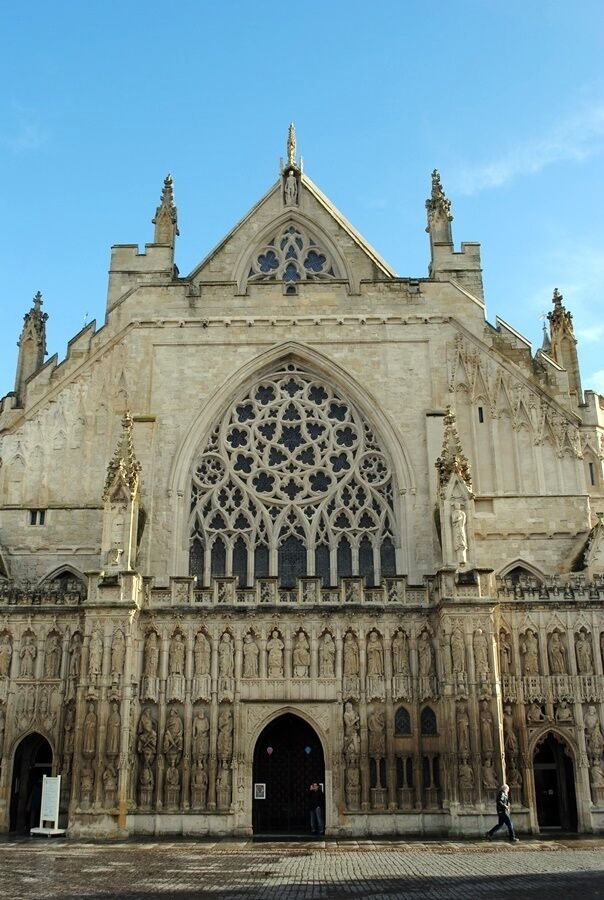 A large Gothic cathedral with intricate stone carvings and a prominent rose window.