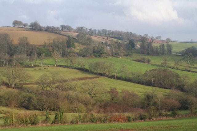 Cadbury: towards Fursdon House. Looking east. Fursdon House is half hidden by trees. The Fursdon family have lived here since the reign of Henry III