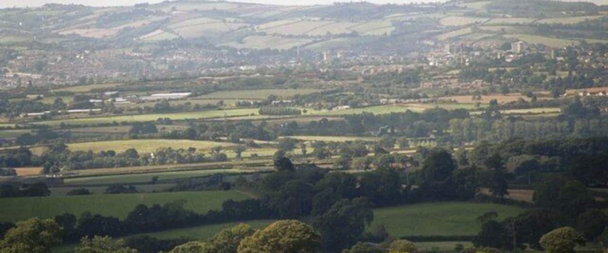 Rolling hills, a distant town, and a river.