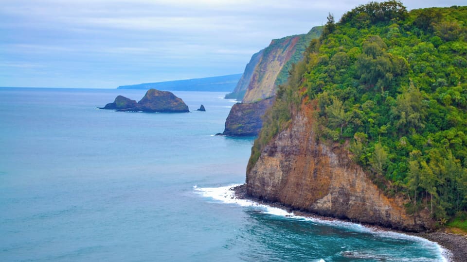 A coastal landscape with cliffs and a calm sea.