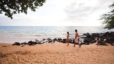 A beach with rocky shoreline and calm sea.