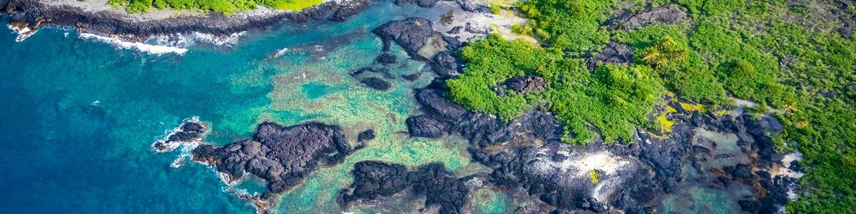 Aerial view of turquoise water and rugged coastline over Keauhou Point Hawaii