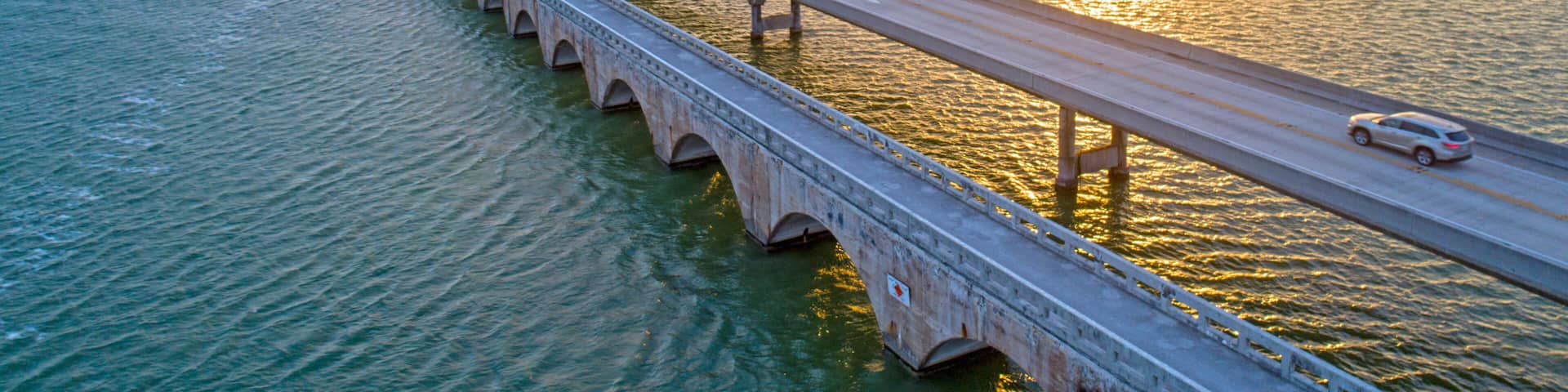 Overseas Highway Seven Mile Bridge Traffic at Sunrise. View From Florida Keys Tropical Road to Paradise