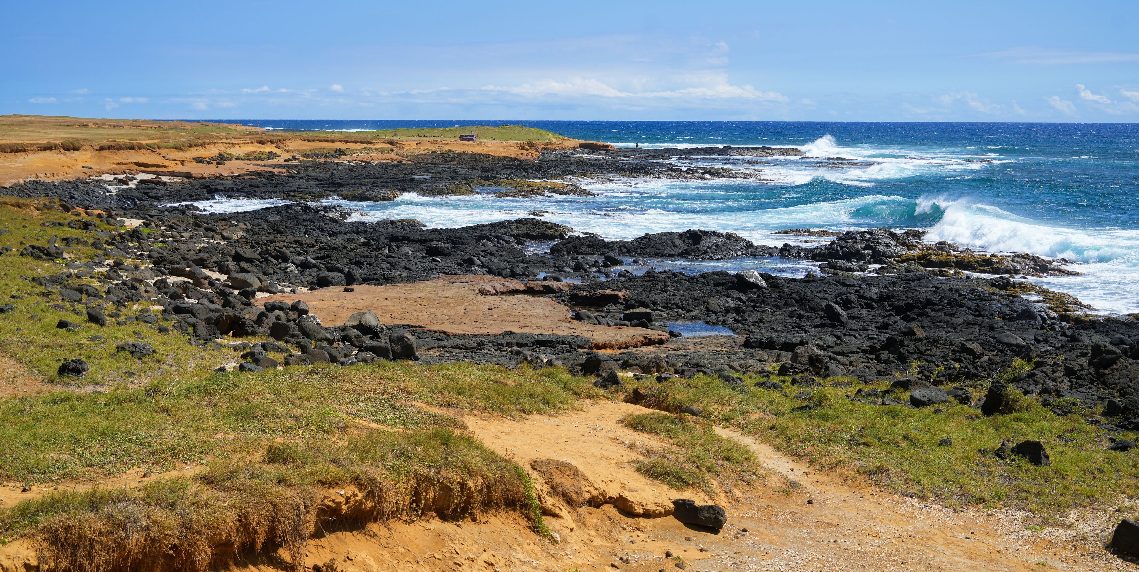 Waves crashing on the lava rocks of South Point Park, the southernmost point of the United States on the Big Island of Hawaii in the Pacific Ocean