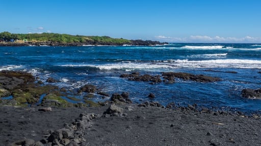 Punaluu Beach has black sand made of basalt and created by lava flowing into the ocean which explodes as it reaches the ocean and cools.; Shutterstock ID 387623206; PO: Hcom Destination Content neighb