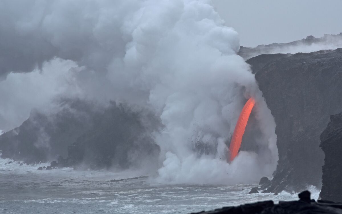 The ocean entry in Kalapana that was created when a 4 acre chunk of coastline fell into the sea leaving an open hole in the cliff face shooting hot magma into the ocean. The sight of this in the middle of an overcast  day is incredible. It has been raining for 3 days so this was our first trip out to the ocean entry.