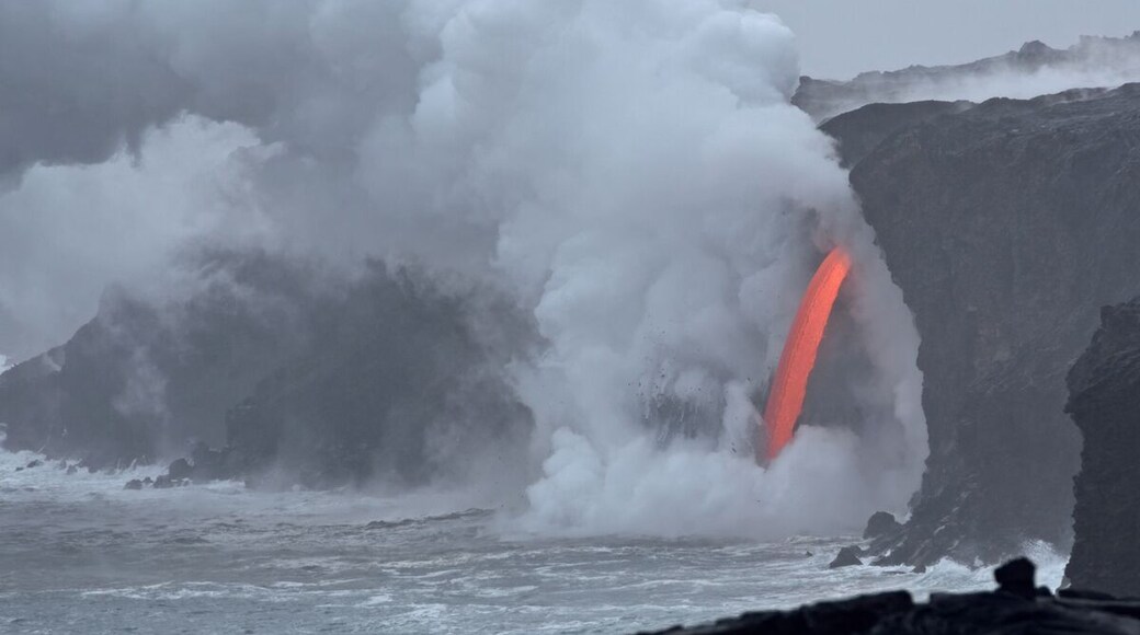 The ocean entry in Kalapana that was created when a 4 acre chunk of coastline fell into the sea leaving an open hole in the cliff face shooting hot magma into the ocean. The sight of this in the middle of an overcast day is incredible. It has been raining for 3 days so this was our first trip out to the ocean entry.