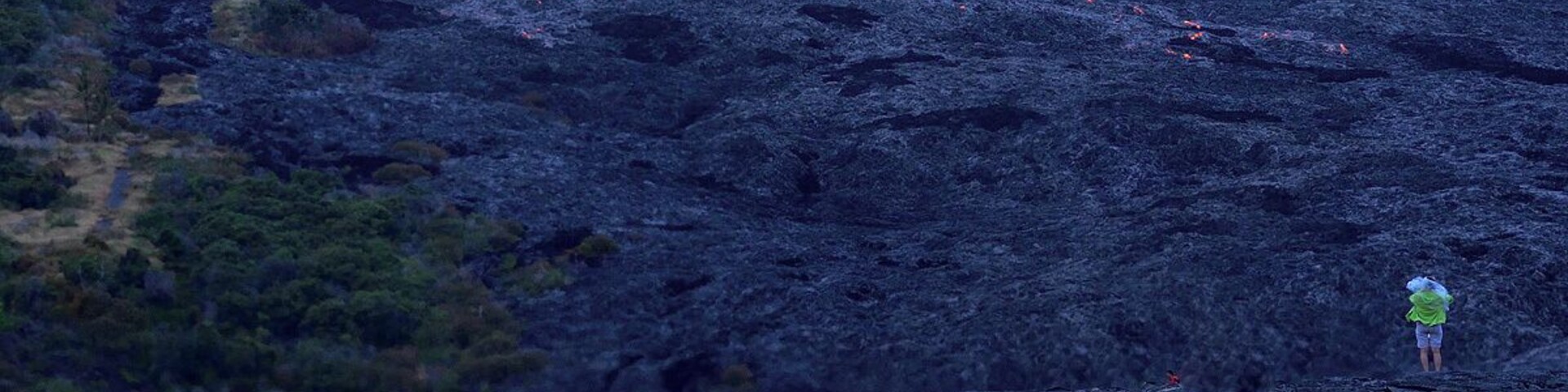 #NationalPark My wife standing near a large lava flow. Check out the lava above and beneath her. You have to respect lava if you venture into the active areas. If you slip and fall the consequences are bad. Lava reaches temperatures of 2200 degrees which will vaporize wood. It almost feels like tapioca when you put a stick in it.