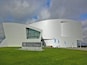 The University of Alaska Museum of the North building with a modern design and a grassy foreground.