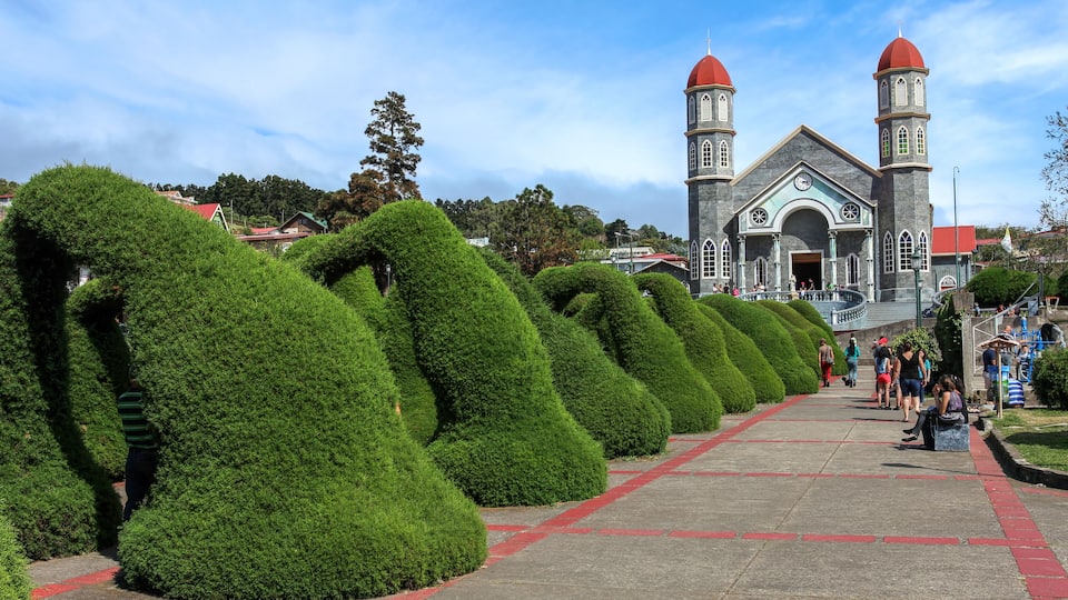 A church with two red domes and a clock tower.