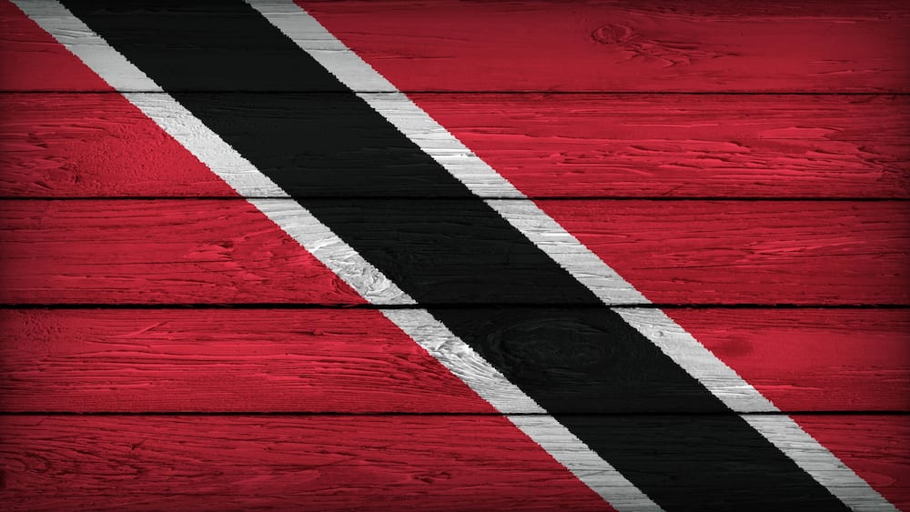 The flag of TRINIDAD painted on a wooden table with Original Colors