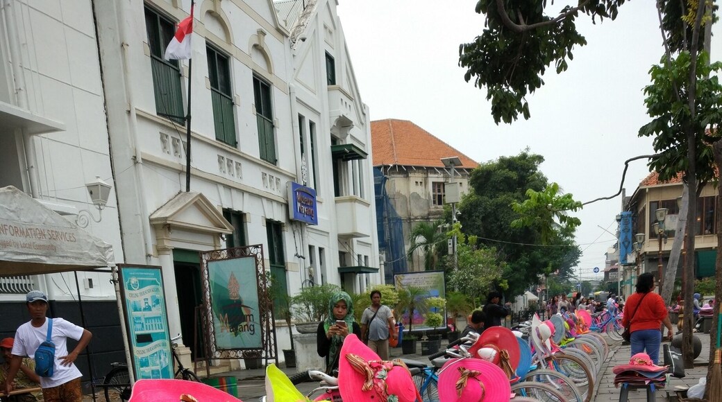 Brightly coloured bikes for hire (with matching hats) in Jakarta