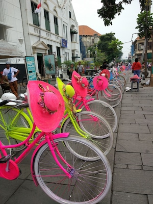 Brightly coloured bikes for hire (with matching hats) in Jakarta