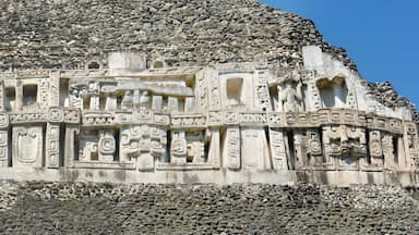 A large stone pyramid with intricate carvings and a stepped structure.
