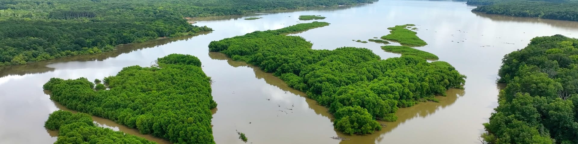 Big river water with green islands at Roanoke and Stauton River convergence in Virginia camping destination for families and fishermen on summer vacation