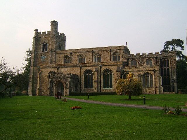 A historic stone building with arched windows and a tower.