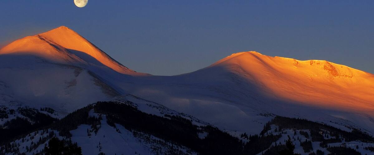 Breckenridge featuring snow, mountains and a sunset