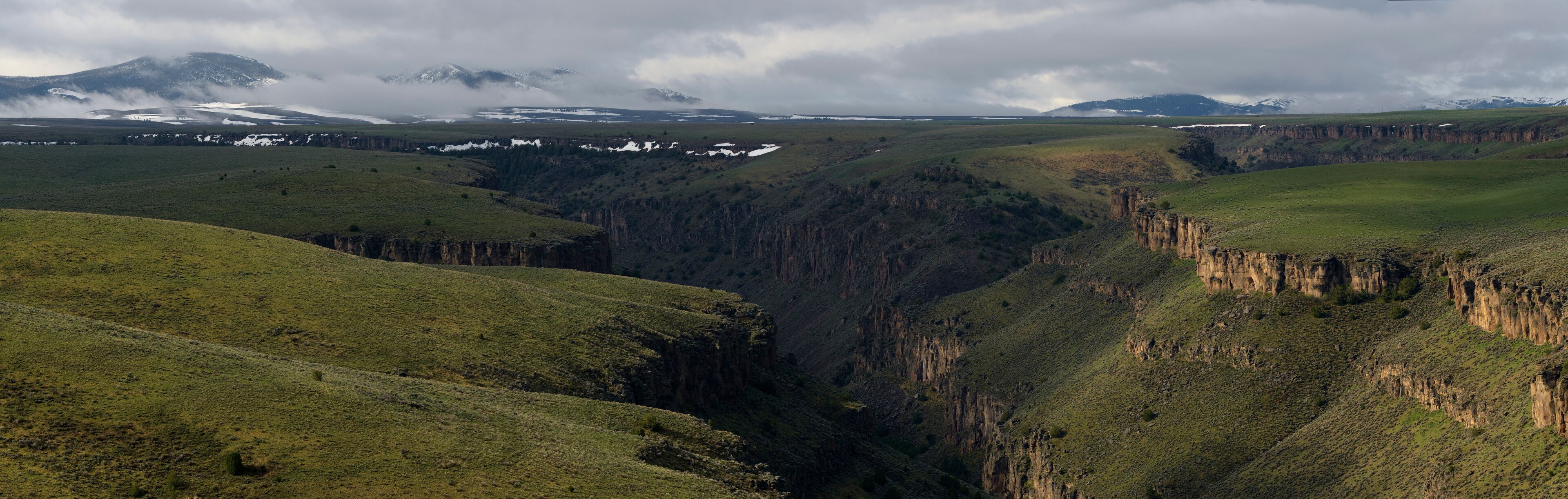 A canyon with steep cliffs and a valley.