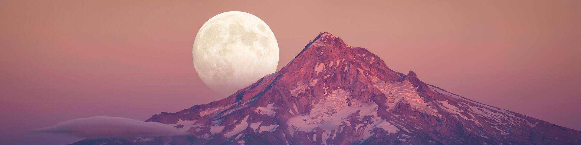 Scenic view of full moon rising behind Mount Hood at dusk