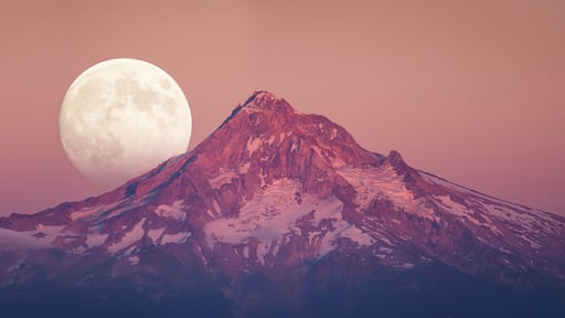 Scenic view of full moon rising behind Mount Hood at dusk